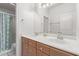 Bathroom with dual sinks, a large mirror, and a shower with a floral curtain at 1349 E Anasazi St, Mesa, AZ 85203