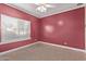 A bright bedroom featuring neutral carpet, window blinds, and a ceiling fan at 1349 E Anasazi St, Mesa, AZ 85203