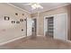 Bedroom with carpet, square wall decorations, closet, and bathroom access at 1349 E Anasazi St, Mesa, AZ 85203