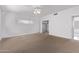 Bright bedroom features neutral carpet, a ceiling fan, a window with blinds, and access to a closet at 1349 E Anasazi St, Mesa, AZ 85203