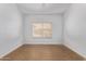 A simple bedroom, with hardwood floors, natural light, and neutral walls at 1349 E Anasazi St, Mesa, AZ 85203