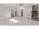 A tiled bonus room featuring a staircase and multiple doors at 1349 E Anasazi St, Mesa, AZ 85203