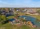 Beautiful community pond with a waterfall and dock, surrounded by lush green grass and trees, in a well-maintained neighborhood at 1349 E Anasazi St, Mesa, AZ 85203