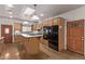 Bright kitchen featuring stainless steel appliances, center island, granite countertops, and ample cabinet space at 1349 E Anasazi St, Mesa, AZ 85203