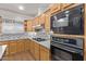 Close-up of kitchen appliances and cabinets with mosaic tile backsplash and granite countertops at 1349 E Anasazi St, Mesa, AZ 85203