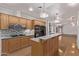 Well-equipped kitchen featuring a center island with breakfast bar, granite countertops, and updated appliances at 1349 E Anasazi St, Mesa, AZ 85203