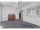 Sunlit living room with piano, grey carpet, and arched entrance to the foyer at 1349 E Anasazi St, Mesa, AZ 85203