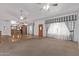 Bright living room with high ceilings, ceiling fans, and neutral tones, flowing into the kitchen area at 1349 E Anasazi St, Mesa, AZ 85203