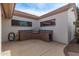 Backyard view of built-in outdoor kitchen with stainless steel grill and sink on covered patio at 1349 E Anasazi St, Mesa, AZ 85203