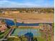 Aerial shot of neighborhood tennis courts near greenbelt canal, highlighting recreational amenities and community features at 1349 E Anasazi St, Mesa, AZ 85203