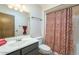 Bathroom with single sink vanity and shower with patterned curtain at 13842 N 109Th Ave, Sun City, AZ 85351