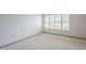 Bright bedroom featuring large window with plantation shutters and neutral carpet at 13842 N 109Th Ave, Sun City, AZ 85351