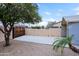 A backyard with a wooden gate, fruit trees, and desert landscaping at 14005 N 19Th Way, Phoenix, AZ 85022