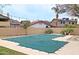 Private backyard pool with a -safe pool cover, string lights, block wall and desert landscaping at 14005 N 19Th Way, Phoenix, AZ 85022