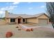 Charming single-story home with a desert landscape, tile roof, and inviting red front door at 14005 N 19Th Way, Phoenix, AZ 85022