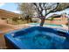 Backyard hot tub with a covered patio and sparkling blue pool at 14005 N 19Th Way, Phoenix, AZ 85022