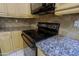 Close up of kitchen featuring smooth top stove, granite counter tops and light cabinets at 14005 N 19Th Way, Phoenix, AZ 85022