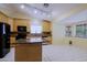 Bright kitchen with tile flooring, an island, granite countertops, and stainless steel appliances at 14005 N 19Th Way, Phoenix, AZ 85022