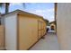 Exterior view of an outdoor storage shed with a wooden door and painted siding at 14005 N 19Th Way, Phoenix, AZ 85022