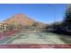 Community tennis court set against a scenic mountain backdrop, offering a healthy recreational amenity at 14005 N 19Th Way, Phoenix, AZ 85022