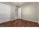 Neutral bedroom featuring a ceiling fan, closet, and wood-style flooring at 14408 N 35Th Ave, Phoenix, AZ 85053