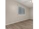 Neutral bedroom with laminated floors and large window with blinds at 14408 N 35Th Ave, Phoenix, AZ 85053