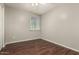 Cozy bedroom featuring a window view and wood-style flooring at 14408 N 35Th Ave, Phoenix, AZ 85053