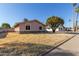 Side view of a single-story home featuring desert landscaping and arched windows at 14408 N 35Th Ave, Phoenix, AZ 85053