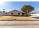 Front view of a single-story home featuring desert landscaping and arched windows at 14408 N 35Th Ave, Phoenix, AZ 85053