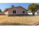 Rear view of a single-story home featuring desert landscaping and arched windows at 14408 N 35Th Ave, Phoenix, AZ 85053