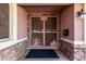 Welcoming front door featuring a decorative screen door with southwest desert art and stone accents at 14408 N 35Th Ave, Phoenix, AZ 85053