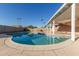 Outdoor in-ground pool and covered patio with blue skies and palm trees at 14408 N 35Th Ave, Phoenix, AZ 85053