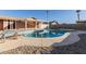 A sunny backyard features a pool, paved pool deck and gravel ground cover at 14408 N 35Th Ave, Phoenix, AZ 85053