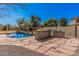 Backyard with a pool, built-in bar with grill, and desert landscaping under a clear blue sky at 1481 E Lark St, Gilbert, AZ 85297