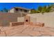 Backyard featuring an outdoor fireplace, stone seating, and privacy walls at 1481 E Lark St, Gilbert, AZ 85297