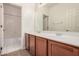 Bathroom with double sink vanity, large mirror, and tiled shower/tub combo at 1481 E Lark St, Gilbert, AZ 85297