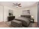 Comfortable bedroom with neutral tones, ceiling fan, dresser, and accent furniture at 1481 E Lark St, Gilbert, AZ 85297