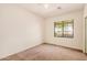 Bright bedroom with carpet, neutral walls, ceiling fan, and large window at 1481 E Lark St, Gilbert, AZ 85297