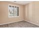 Empty bedroom with laminate floors, neutral walls, white trim, and a window with shutters at 1481 E Lark St, Gilbert, AZ 85297