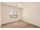 Bright bedroom with carpet, neutral walls, ceiling fan, and window with neighborhood views at 1481 E Lark St, Gilbert, AZ 85297