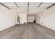 Spacious, empty garage with water heater, two doors, and concrete flooring at 1481 E Lark St, Gilbert, AZ 85297