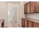 Hallway with built-in cabinets and shelving leading to stairs and a window at 1481 E Lark St, Gilbert, AZ 85297