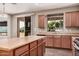 Bright kitchen featuring a large island, wood cabinets, and sliding doors leading to the backyard at 1481 E Lark St, Gilbert, AZ 85297