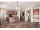 Spacious kitchen with tile flooring, a center island, stainless steel appliances, and wooden cabinetry at 1481 E Lark St, Gilbert, AZ 85297