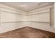 Empty walk-in closet with carpeted floors, white walls, and shelving racks at 1481 E Lark St, Gilbert, AZ 85297