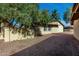 Exterior shot of the property showcasing a rock landscape and mature trees at 14851 N 25Th Dr # 11, Phoenix, AZ 85023