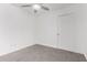 Bedroom features tile floors, ceiling fan, and closet with white door at 14851 N 25Th Dr # 11, Phoenix, AZ 85023