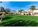 Expansive community lawn showcasing manicured landscaping, nearby homes and trees at 14851 N 25Th Dr # 11, Phoenix, AZ 85023