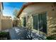 Exterior view of a home's patio with sliding glass doors and a privacy wall with access gate at 14851 N 25Th Dr # 11, Phoenix, AZ 85023