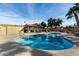 Community pool with an umbrella covered table, lounge chairs, and well kept landscaping at 14851 N 25Th Dr # 11, Phoenix, AZ 85023